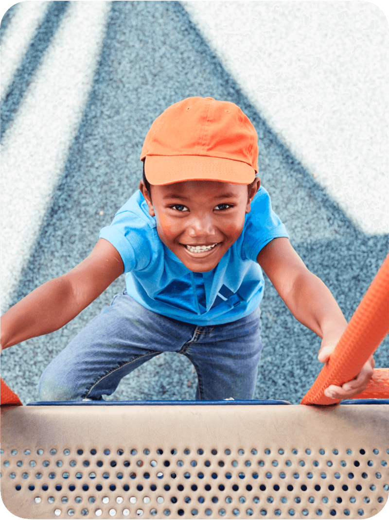 Smiling boy climbing at the playground