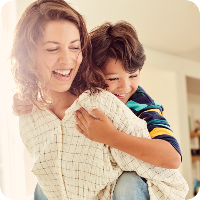 A caregiver carrying a child