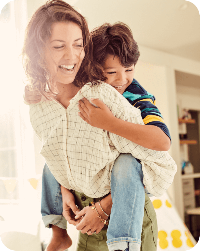 A caregiver carrying a child