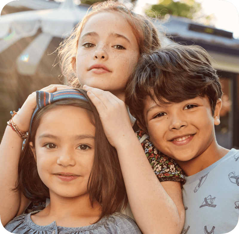 Three children look straight ahead